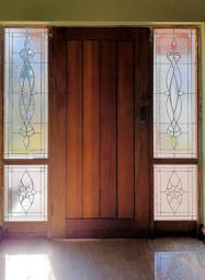 a door with 4 stained glass panels