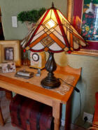 lampshade on a table with clock and photo